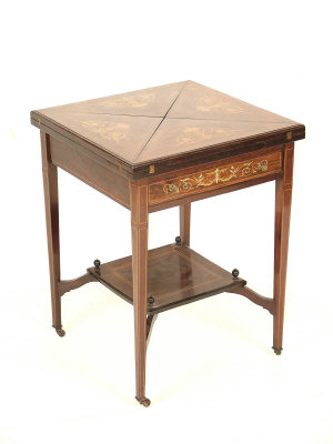 Appraisal: A Victorian rosewood envelope card table the top with floral