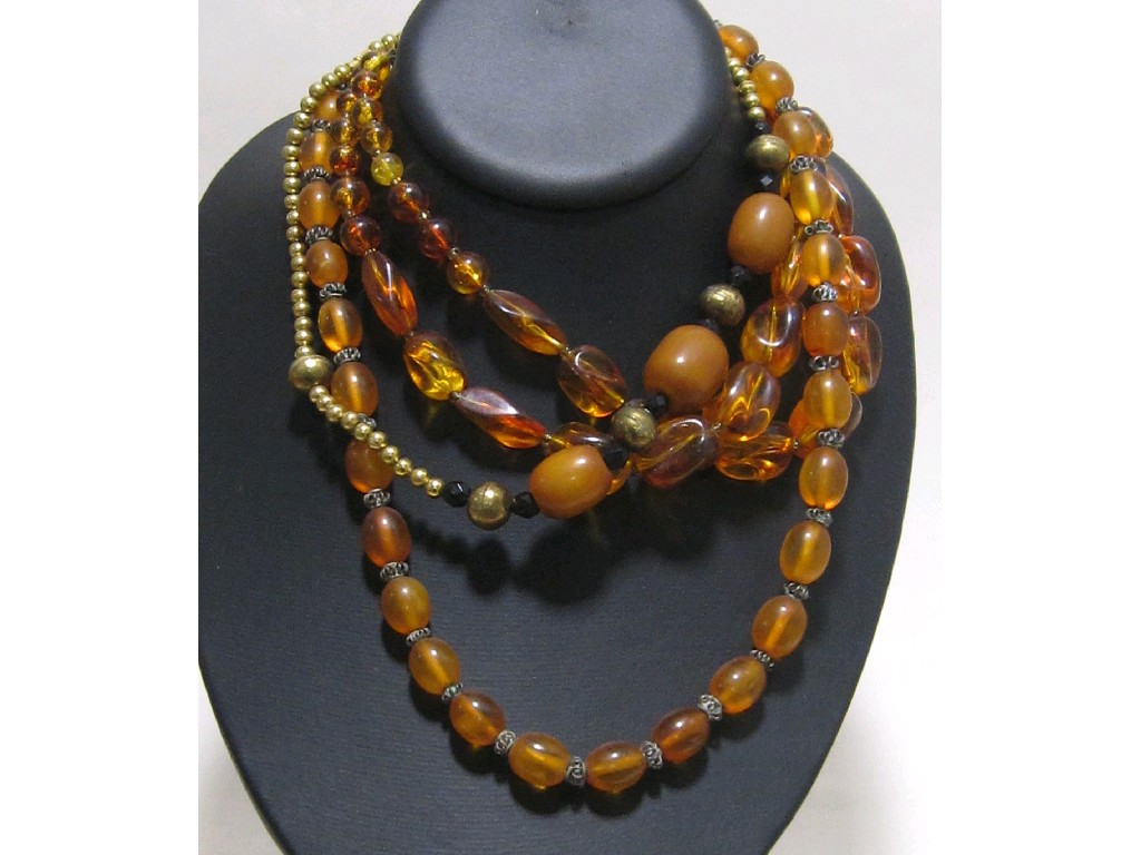 Appraisal: Lot comprising three yellow amber necklaces