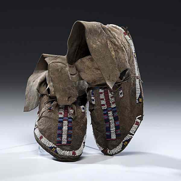 Appraisal: Sioux Beaded Buffalo Hide Moccasins sinew-sewn and beaded using colors