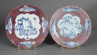 Appraisal: Two Delft manganese fish plates one with exotic figure at