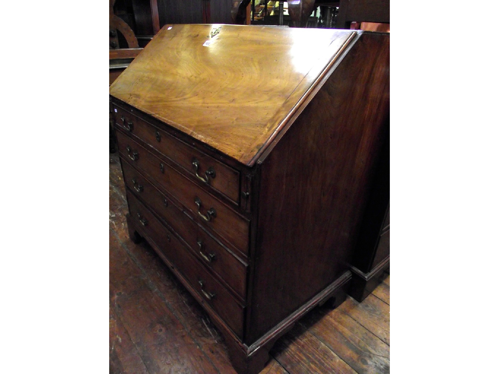 Appraisal: A Georgian mahogany bureau of four long graduated drawers raised