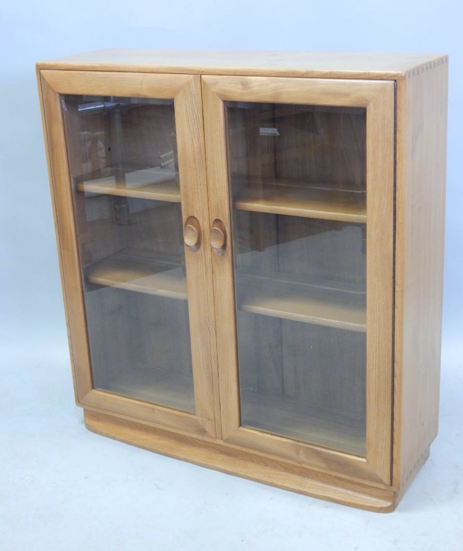 Appraisal: An Ercol light elm display cabinet in retro style with