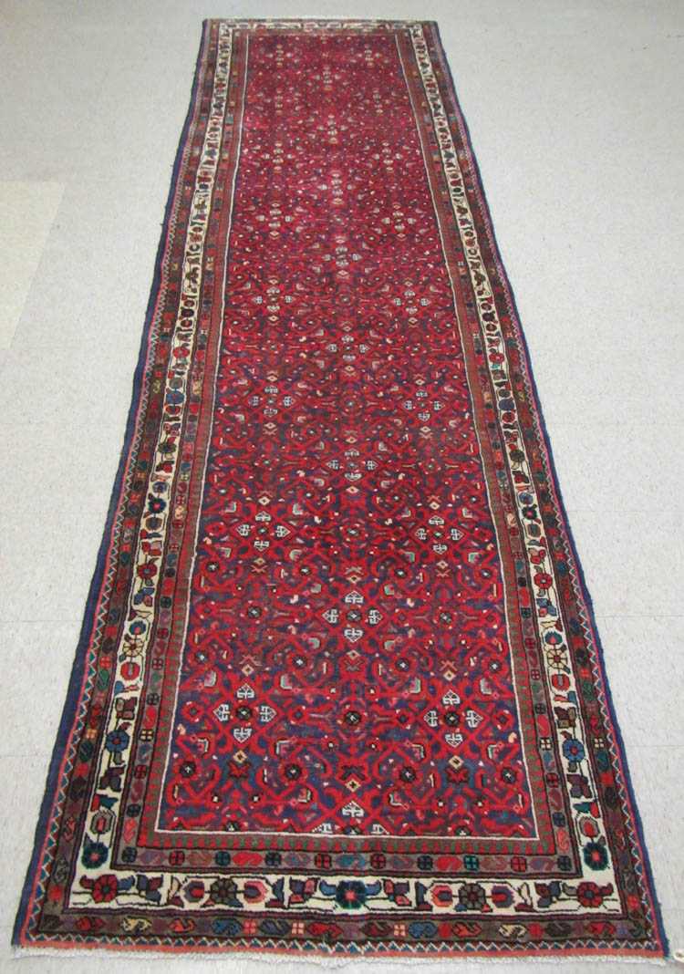 Appraisal: SEMI-ANTIQUE PERSIAN HALL CARPET hand knotted in an overall Herati