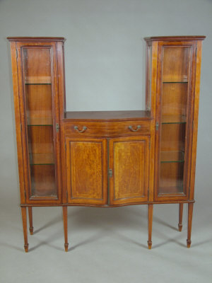 Appraisal: A late Victorian mahogany display cabinet the central serpentine top