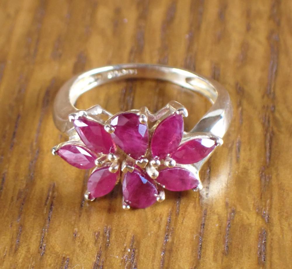 Appraisal: RUBY AND FOURTEEN KARAT GOLD RING set with six marquise-cut