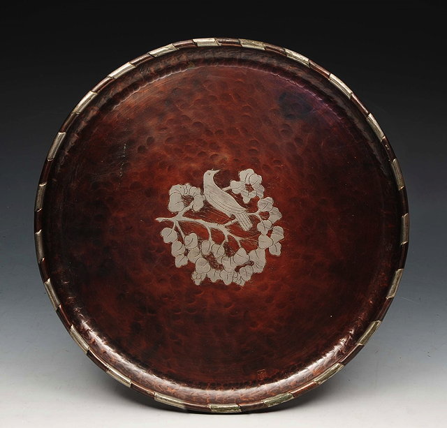 Appraisal: A COPPER AND PEWTER CIRCULAR TRAY by Hugh Wallis decorated