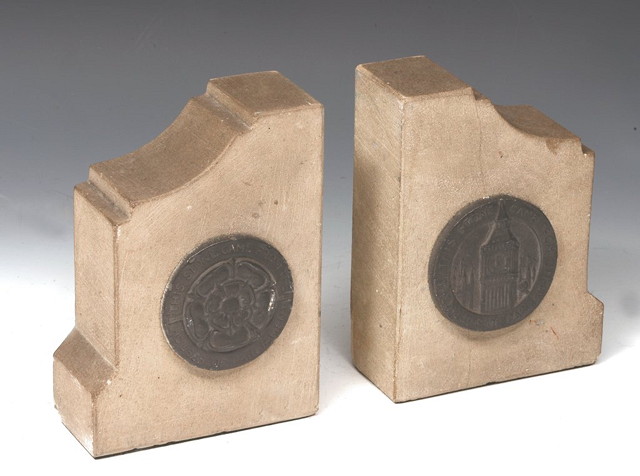 Appraisal: A PAIR OF STONE BOOKENDS each with pewter mount inscribed