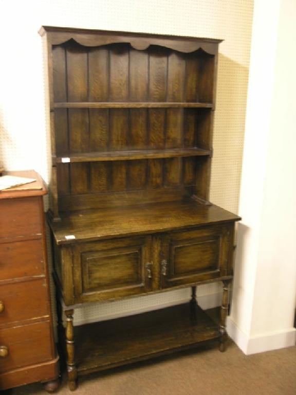 Appraisal: A solid dark oak Welsh dresser two shelf plate back