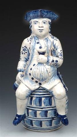 Appraisal: A DUTCH DELFT 'SQUIRE' TOBY JUG the seated figure wearing