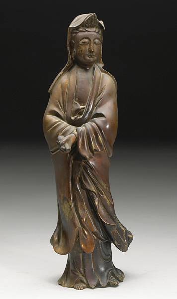 Appraisal: A cast bronze standing Guanyin Standing in a graceful pose