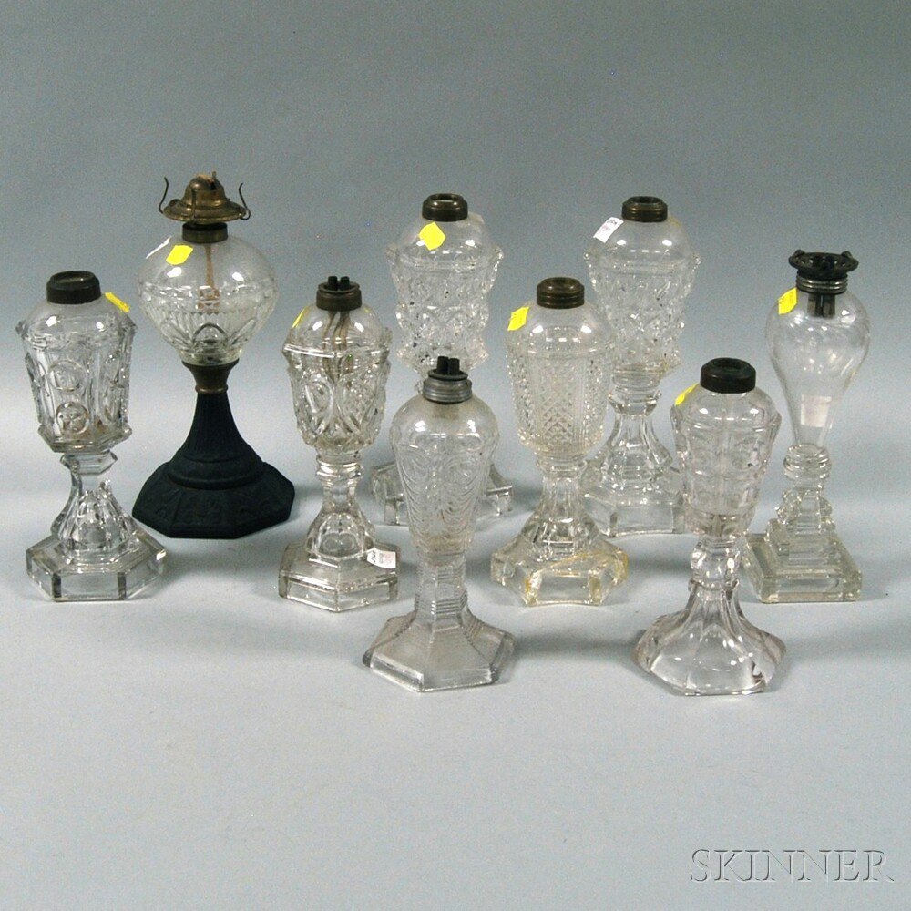 Appraisal: Nine Colorless Pattern Glass Fluid Lamps th century including an