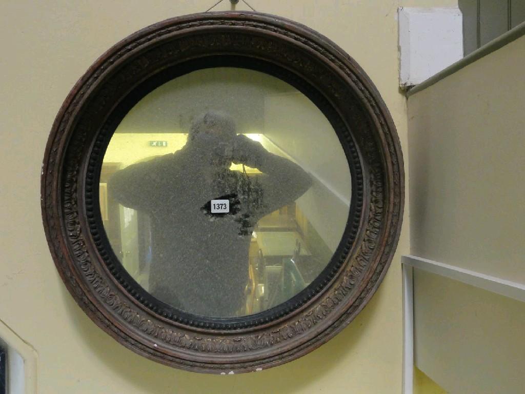 Appraisal: A Regency style wall mirror of circular form with deep