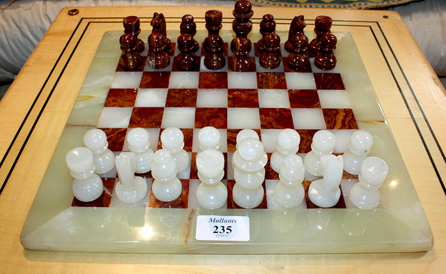 Appraisal: AN ONYX CHESS SET the square board with alternating agate