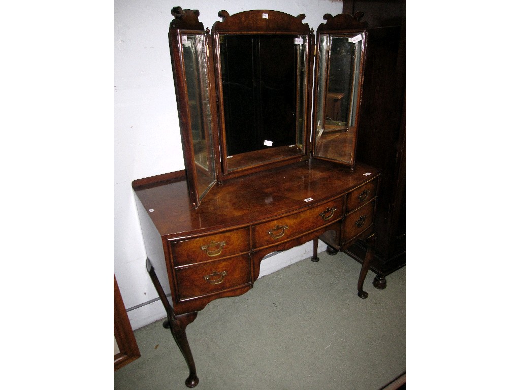 Appraisal: Walnut veneered bow fronted dressing table with triptych mirror