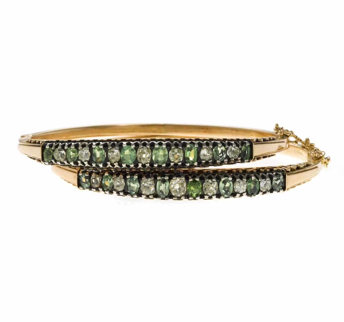 Appraisal: A pair of diamond and demantoid garnet bangle bracelets estimated