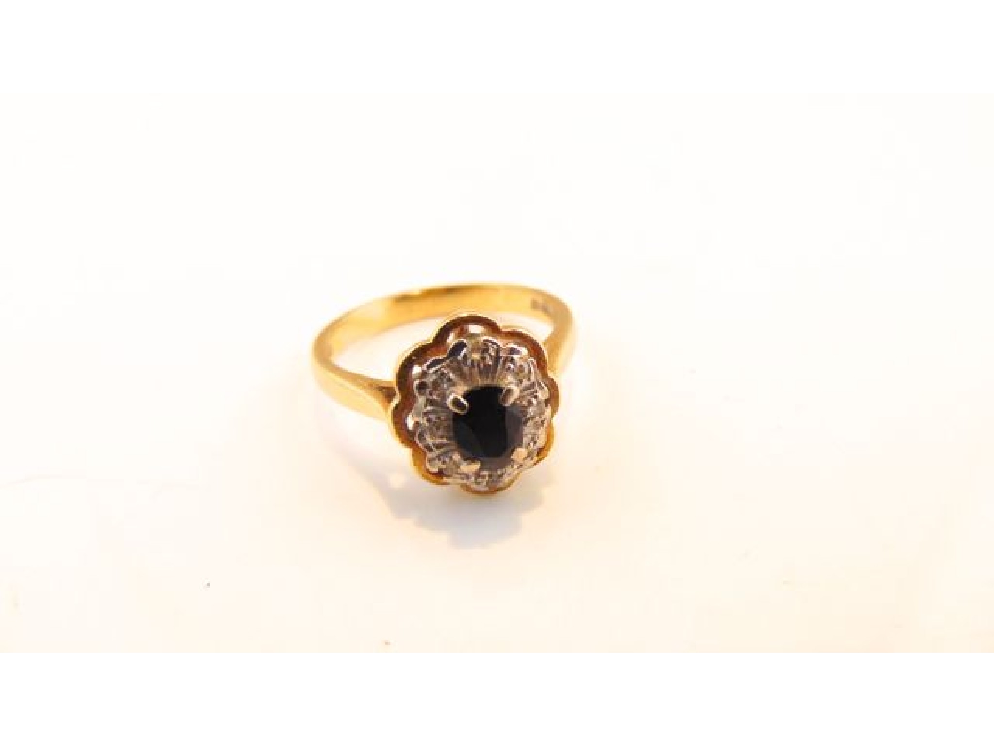 Appraisal: A sapphire and diamond ring centred with an oval mixed-cut