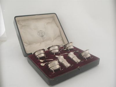 Appraisal: An Edwardian modern seven piece condiment set comprising four circular