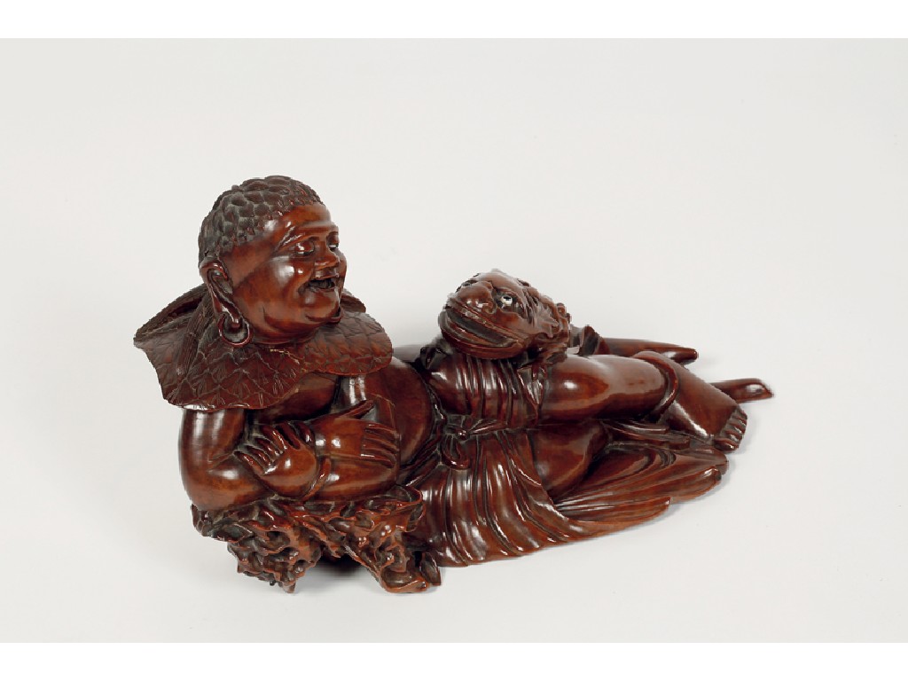 Appraisal: A CHINESE HARDWOOD FIGURE of a deity reclining with a