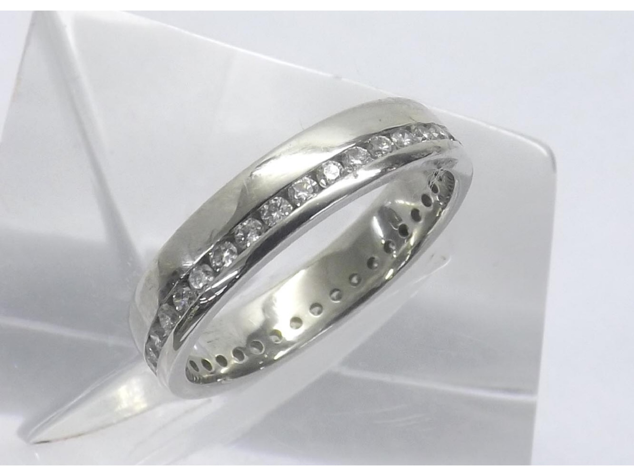 Appraisal: - -a Platinum diamond set platinum wedding band with a