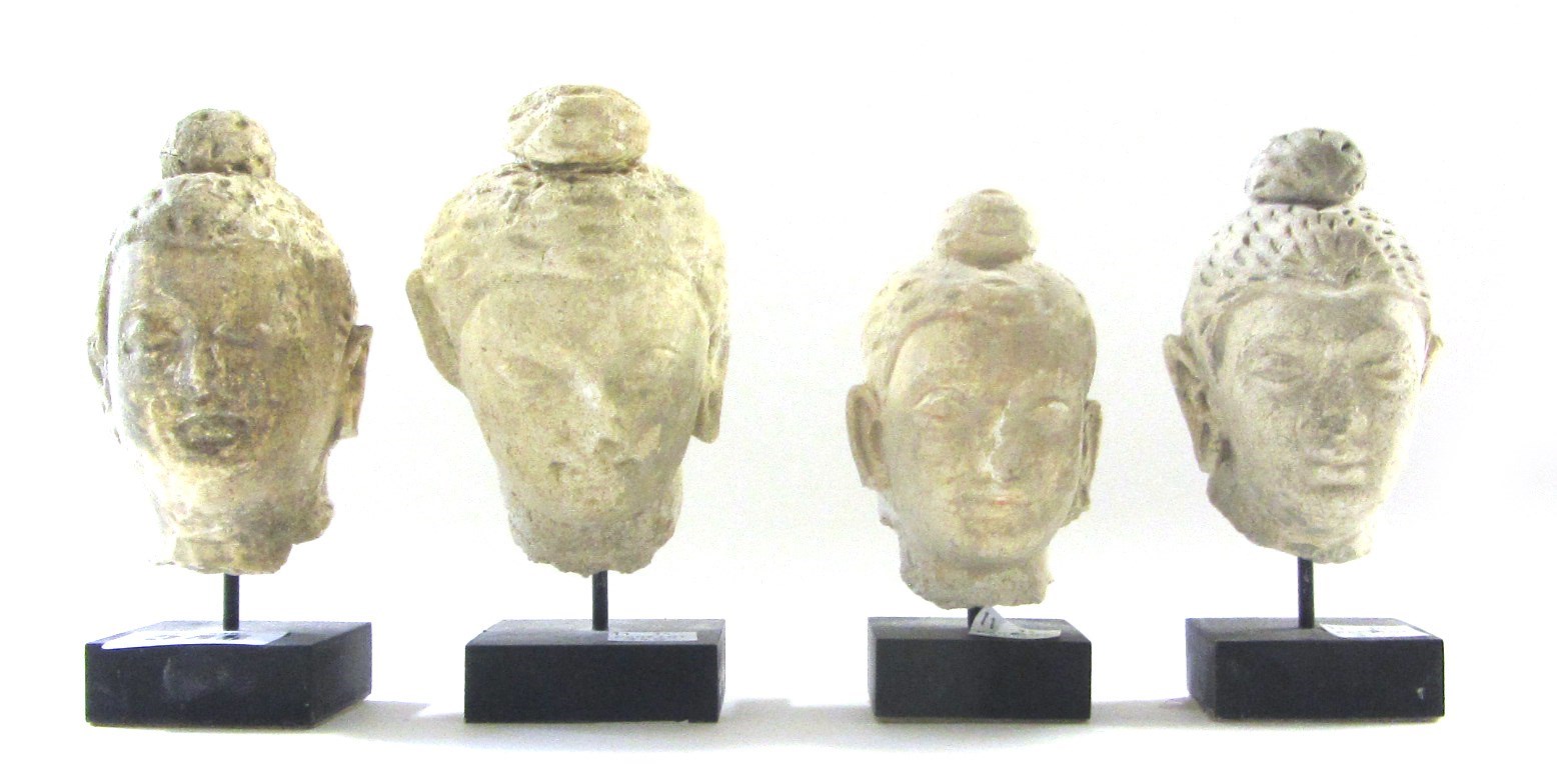 Appraisal: Four Gandharan stucco heads of Buddha th century the hair