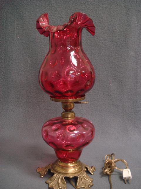 Appraisal: Cranberry glass lamp thumbprint design globe with ruffled edge brass