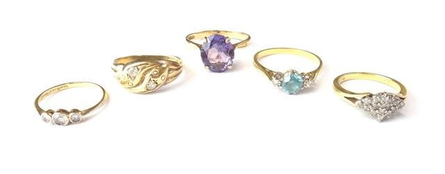 Appraisal: A gold blue zircon and diamond set three stone ring