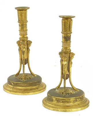 Appraisal: A pair of French gilt brass candlesticks the tapering cylindrical