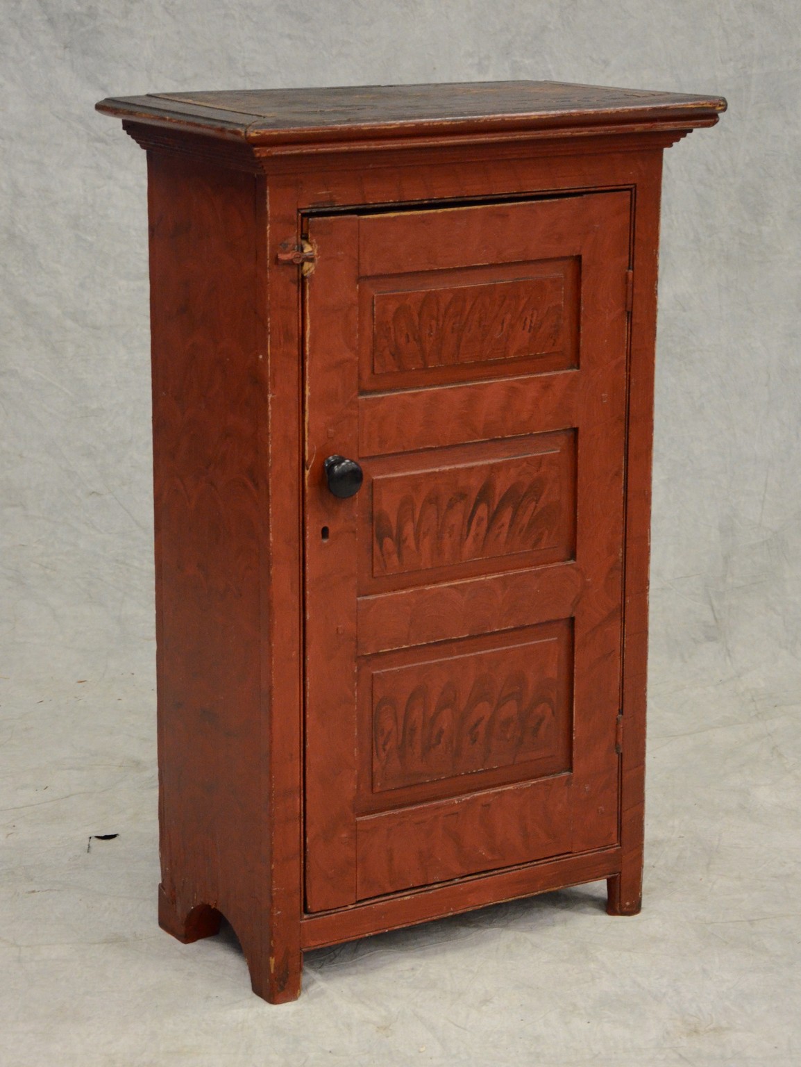 Appraisal: Pine one door hanging cupboard with black and red painted