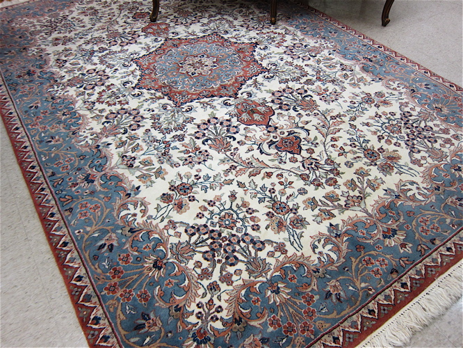 Appraisal: HAND KNOTTED ORIENTAL CARPET Pakistani-Persian floral and central floral medallion