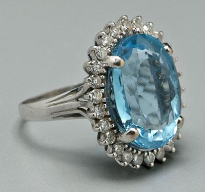 Appraisal: Blue topaz and diamond ring one oval faceted medium to