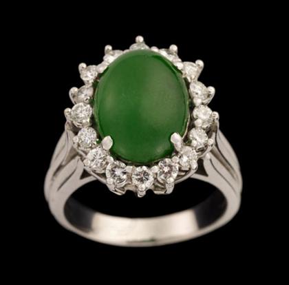 Appraisal: karat white gold jade and diamond ring Dark green oval