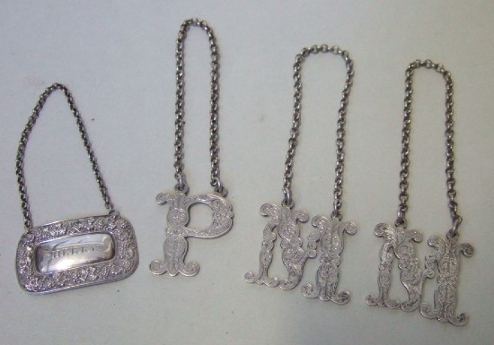 Appraisal: A silver decanter label designed as the initial P with