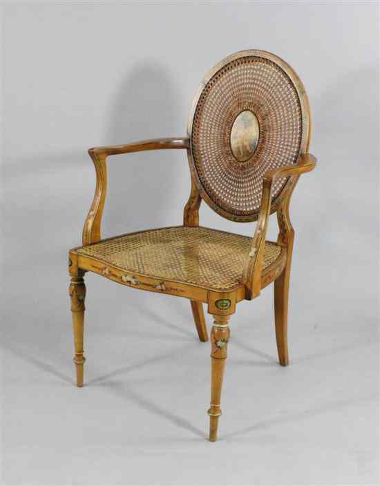 Appraisal: An Edwardian Sheraton revival painted satin birch bergere chair on