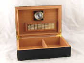 Appraisal: A polished black lacquer cigar humidor with hygrometer x x