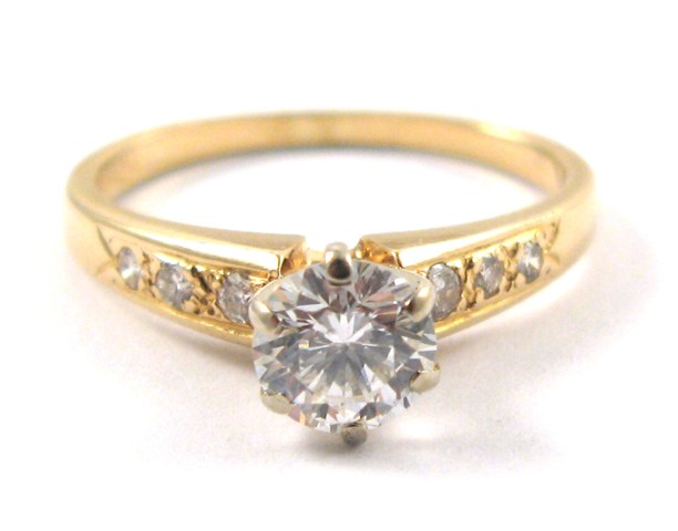 Appraisal: DIAMOND AND FOURTEEN KARAT GOLD RING centering a round brilliant-cut