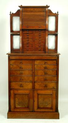 Appraisal: A VICTORIAN BURR WALNUT DENTIST'S CABINET the raised central section