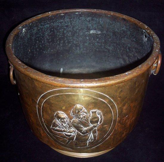 Appraisal: A brass coal pail with embossed oval and lion mask