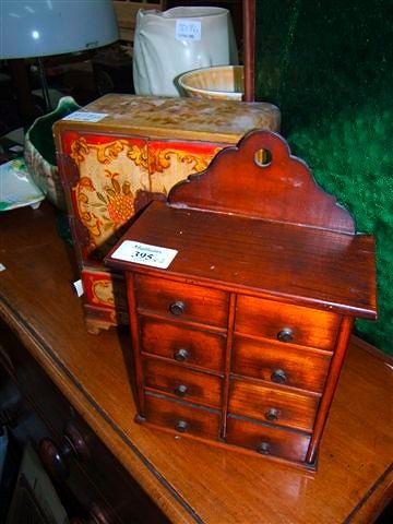 Appraisal: A small fruitwood spice cabinet with eight small drawers wide