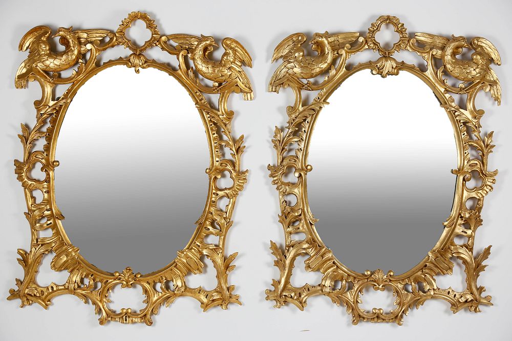 Appraisal: Pair of Carved and Gilt Chippendale Style Oval Mirrors mid