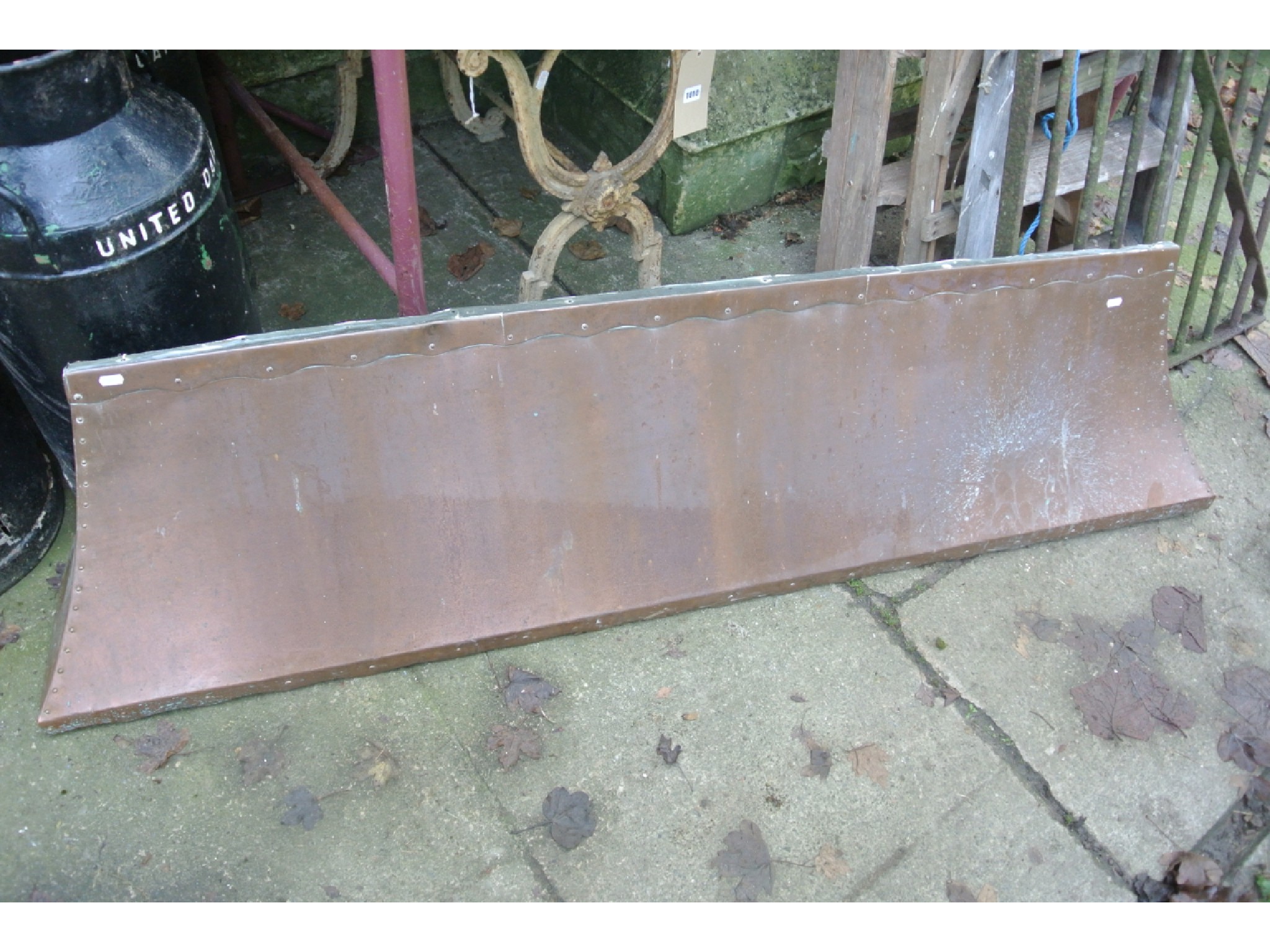 Appraisal: A copper fire hood canopy with wavy edge and riveted