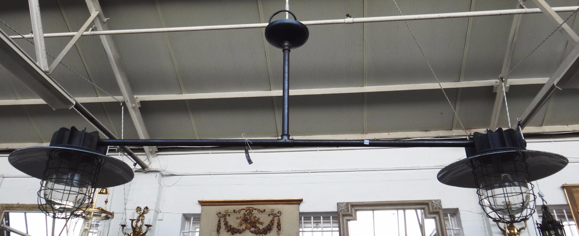 Appraisal: An English iron and enamel industrial twin light fitting mid