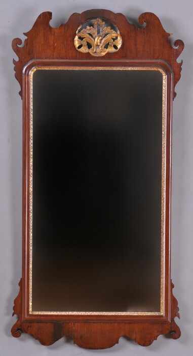 Appraisal: CHIPPENDALE CARVED MAHOGANY AND PARCEL-GILT MIRROR The beveled plate within