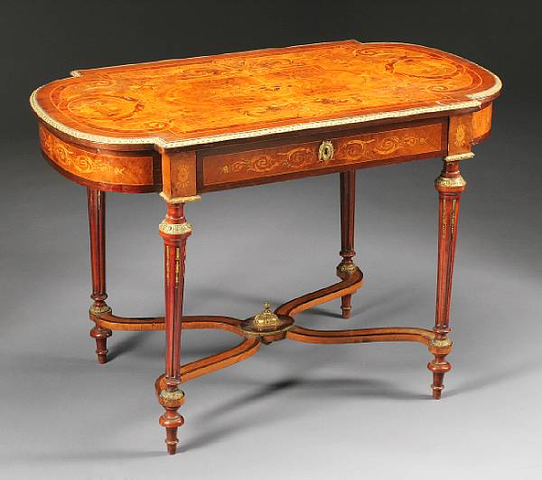 Appraisal: A Louis XVI style marquetry decorated crossbanded yew wood table