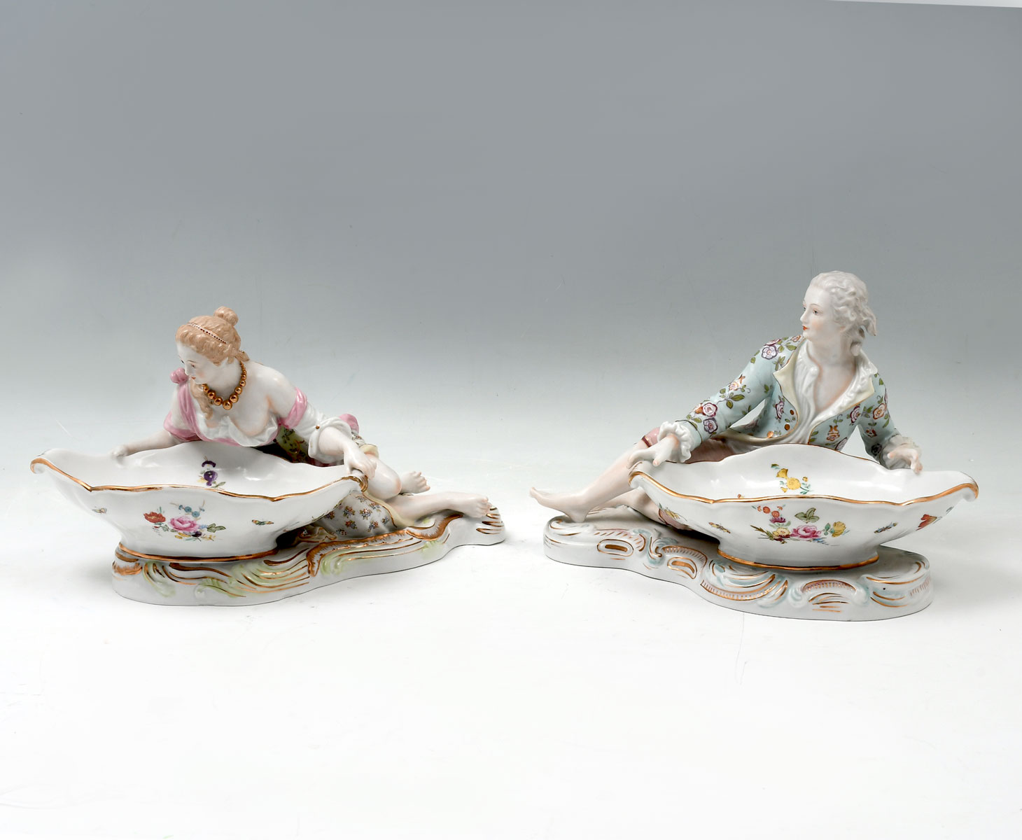 Appraisal: SITZENDORF FIGURAL SWEET MEAT DISHES Opposing male female figures leaning