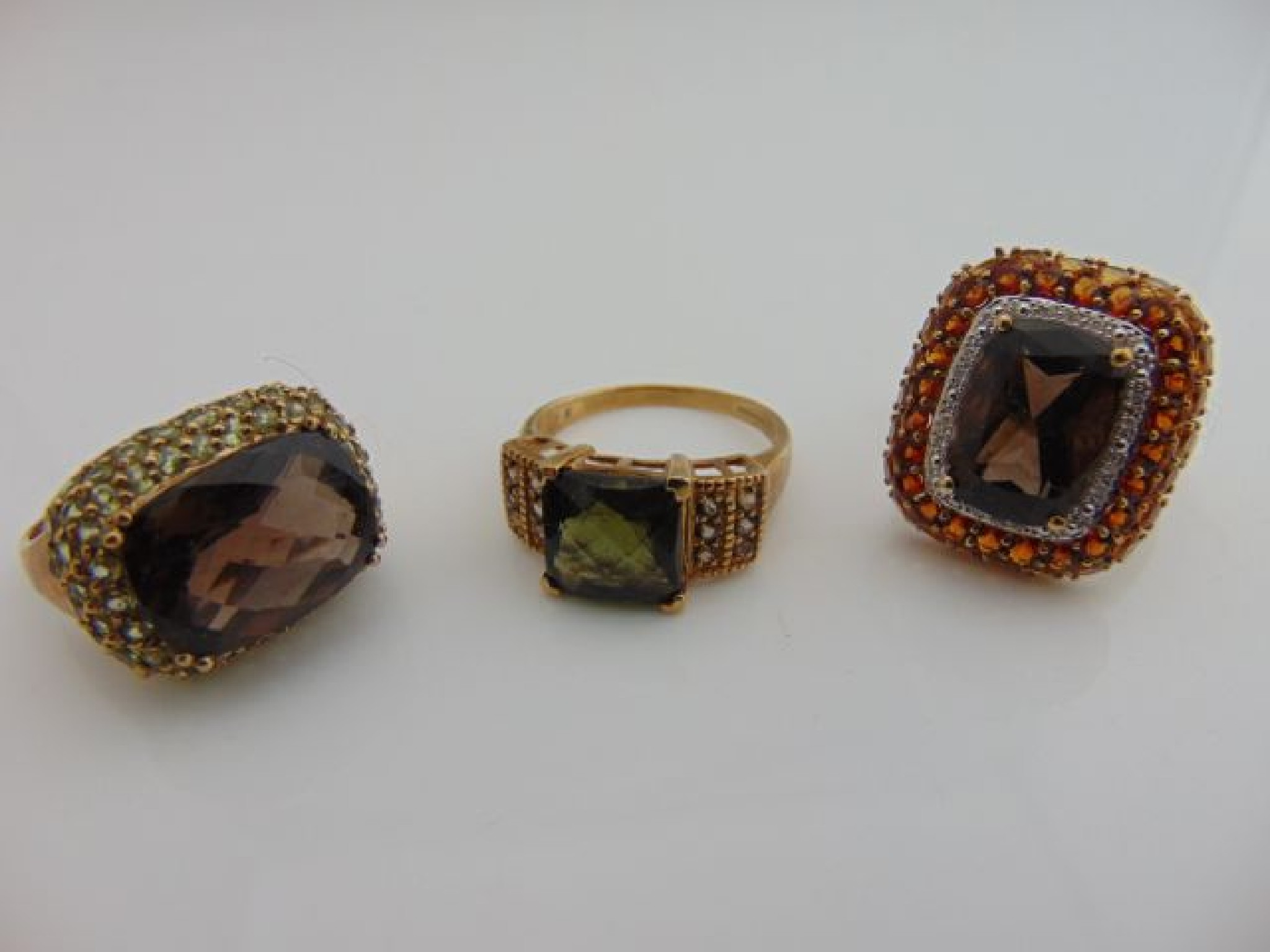 Appraisal: Three gem-set rings two centred with a smoky quartz in