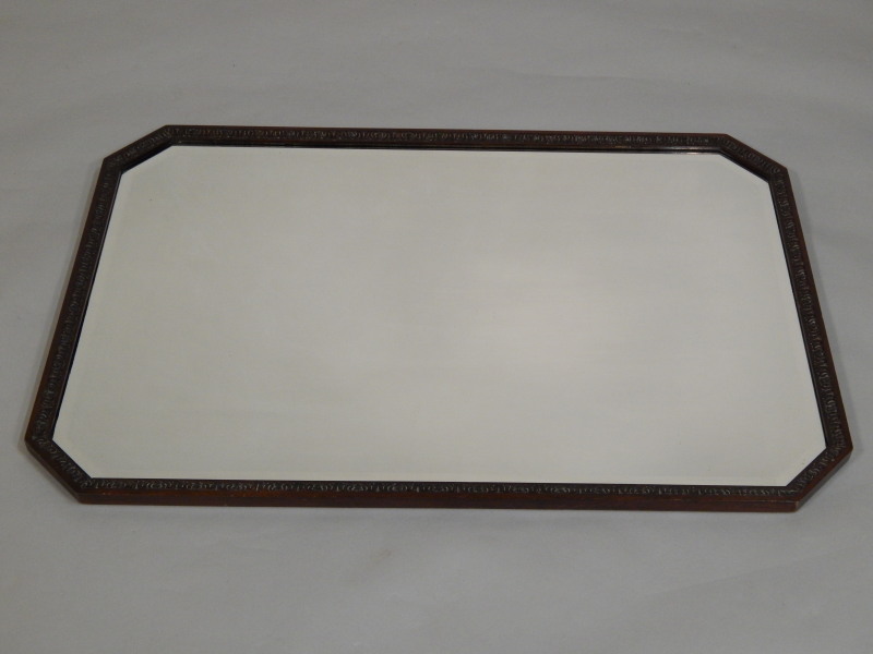 Appraisal: An Edwardian carved mahogany wall mirror with a leaf carved