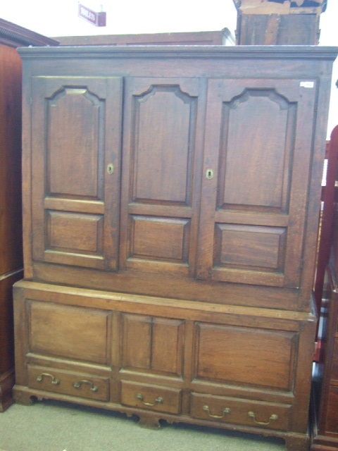 Appraisal: A George III oak wardrobe with a moulded cornice over