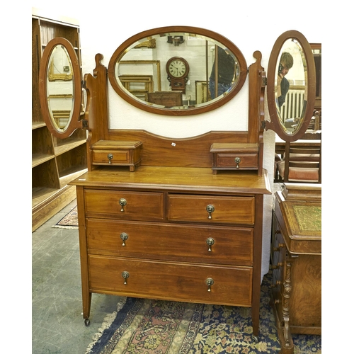 Appraisal: An Edwardian walnut dressing chest with oval mirror brass pear