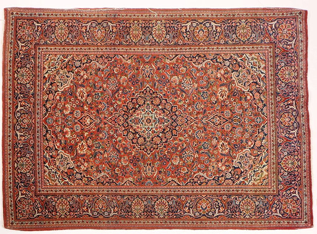 Appraisal: A PERSIAN RED GROUND RUG with a central foliate motif