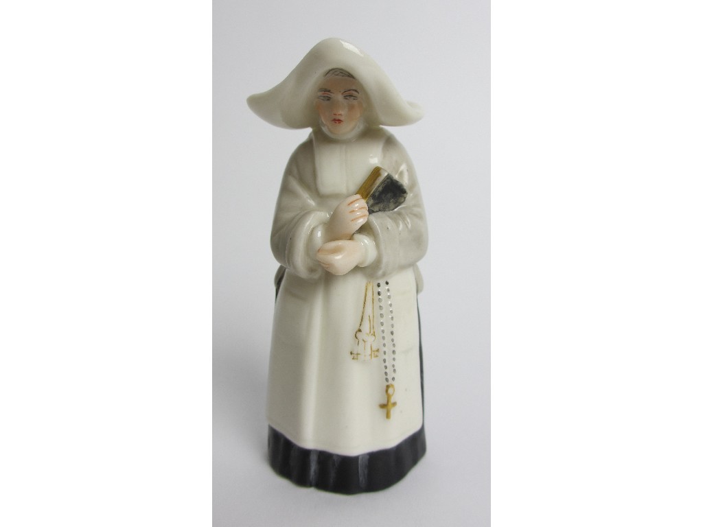 Appraisal: A Royal Worcester candlesnuffer modelled as a nun puce printed